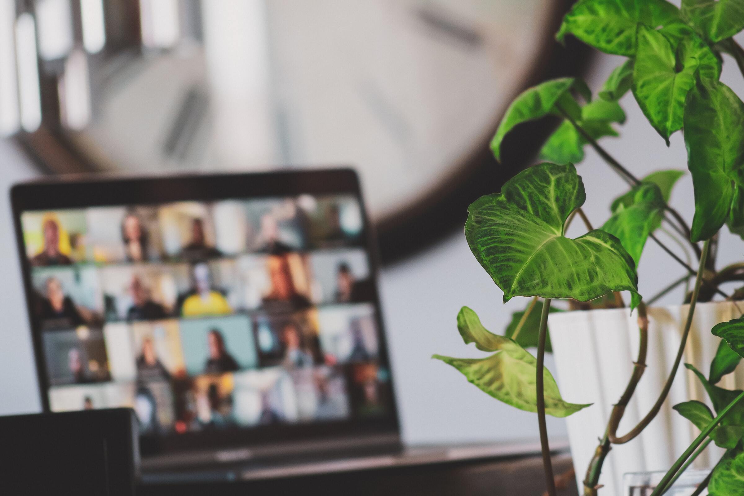 Photo of laptop with online conference on screen